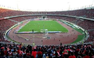 A packed football stadium crowd during a live match