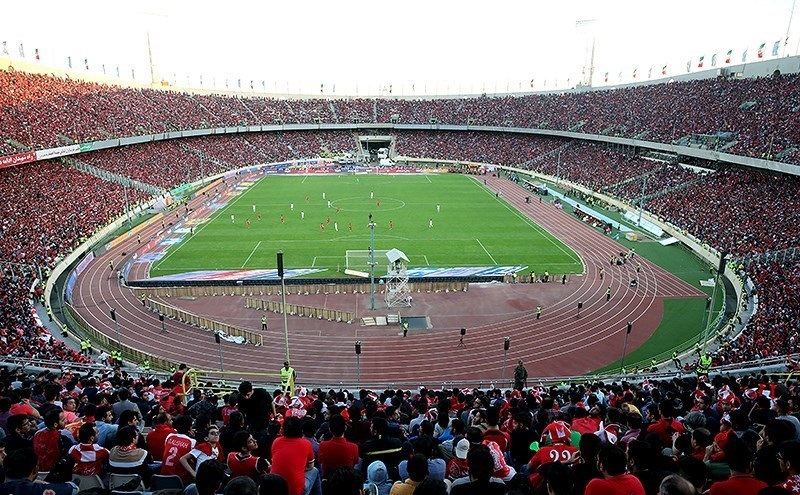 A packed football stadium crowd during a live match